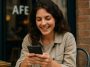 Femme souri qui lis sur telephone